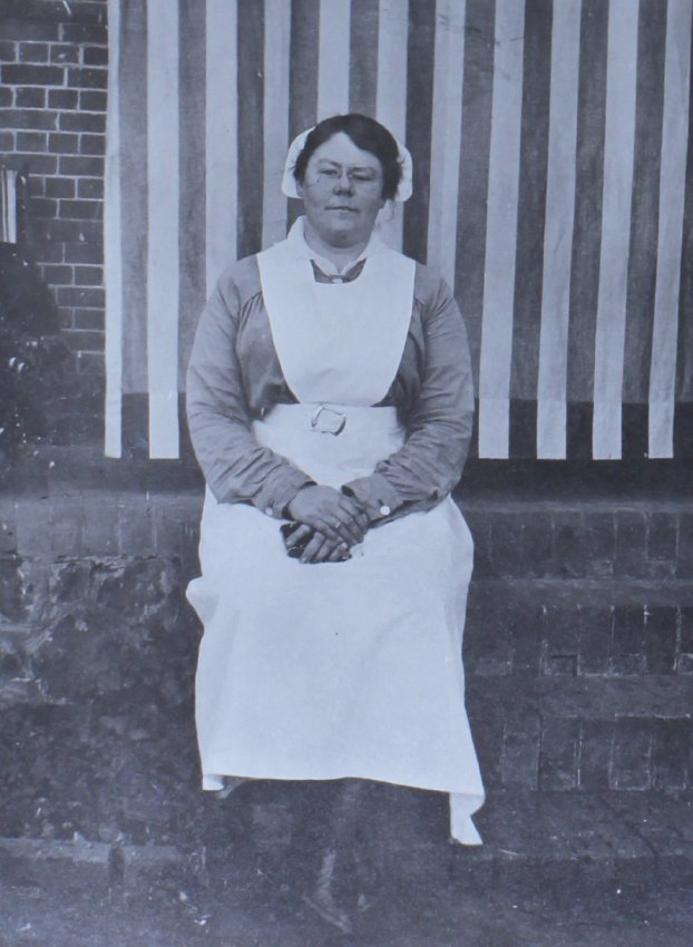 Unidentified woman sitting on a brick wall