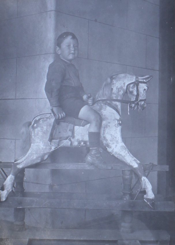Unidentified young boy on a rocking horse
