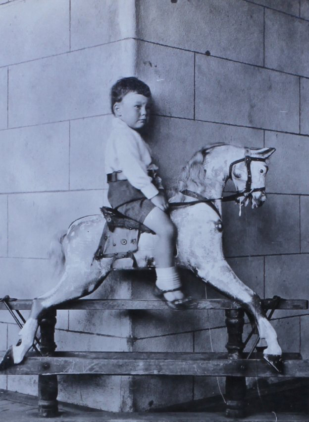 Unidentified young boy on a rocking horse