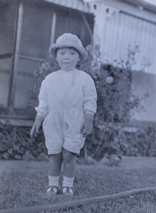 Unidentified child standing on the lawn