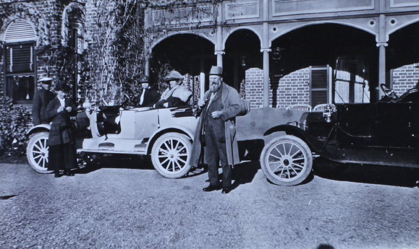 Two man, three women and two cars infront of Saumarez