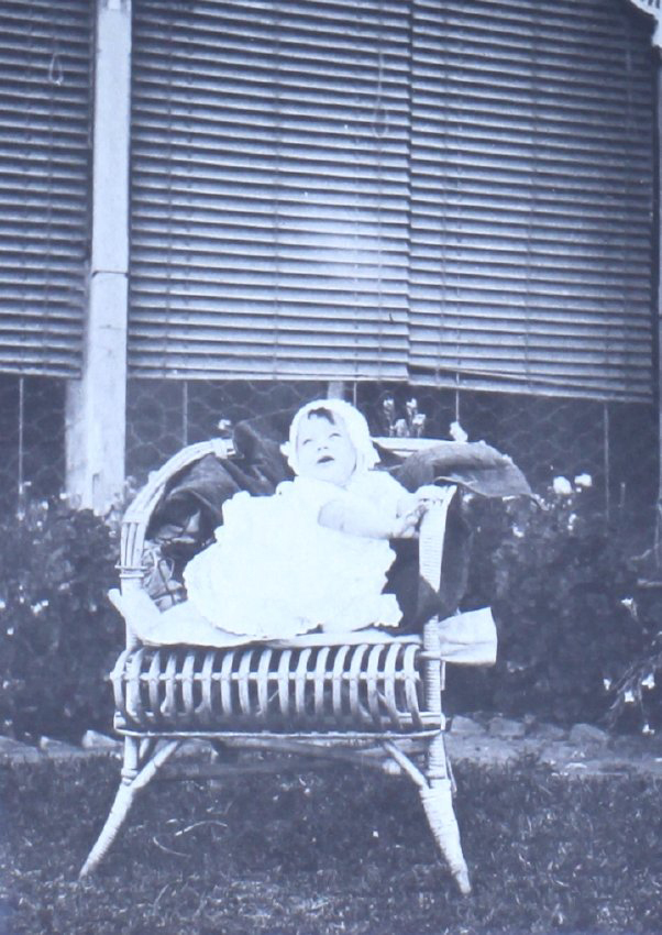 Baby sitting in a chair on the lawn