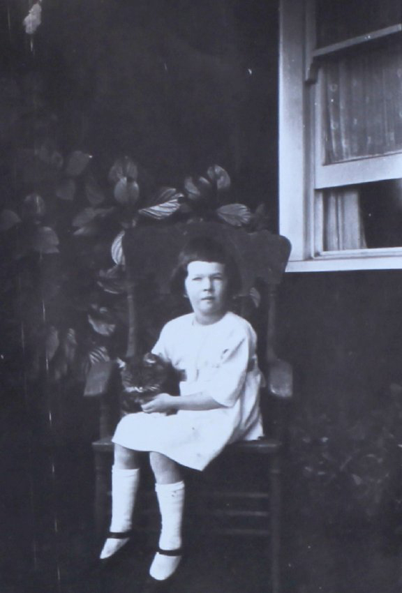 Young girl sitting on a chair with cat