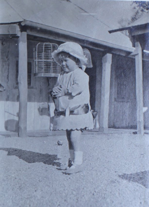 Young girl outside a house