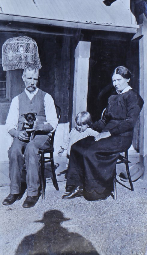 Unidentified man, woman, child and pet dog