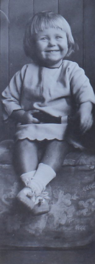 Young girl sitting on a foot stool