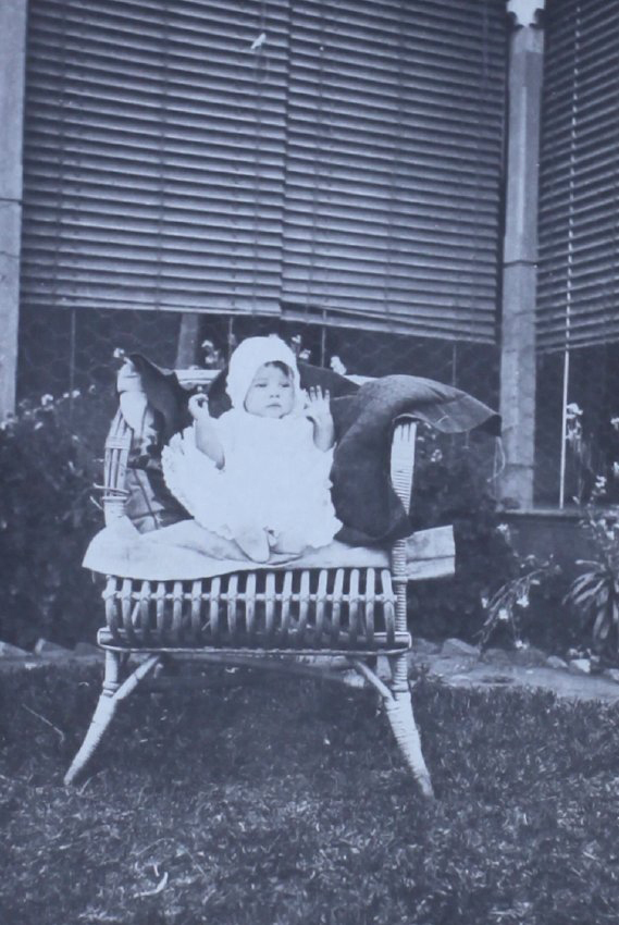 Baby sitting in a cane chair