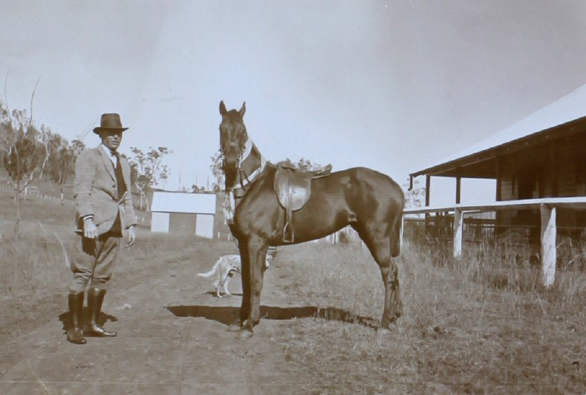 Unidentified man and saddled horse