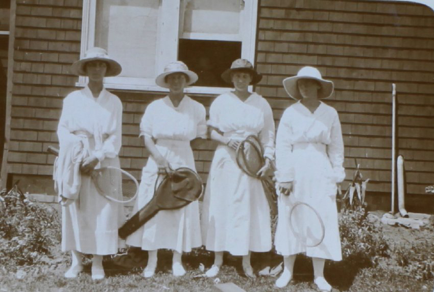 Four women in tennis outfits