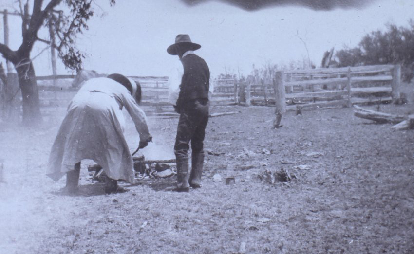 Two men beside a fire