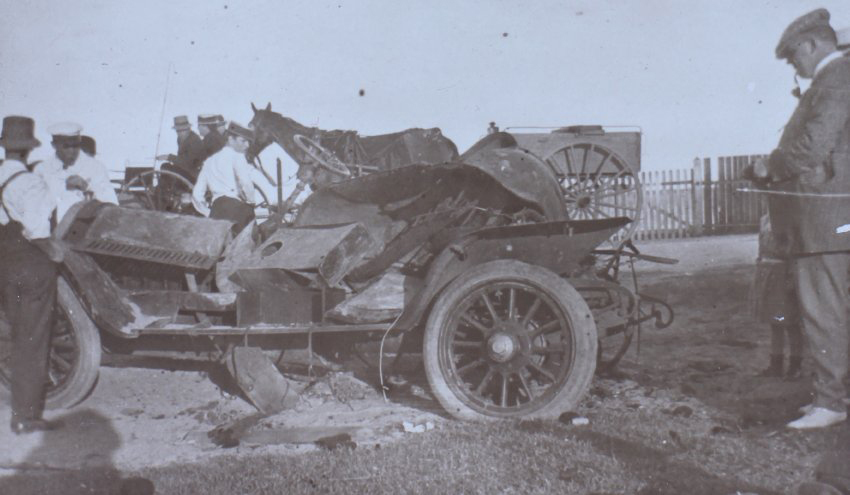 Men standing around a damaged car