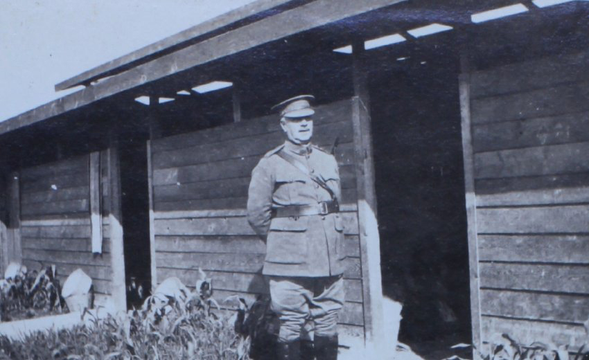 Officer outside timber huts