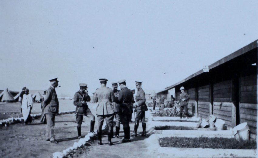 Group of officers outside timber huts