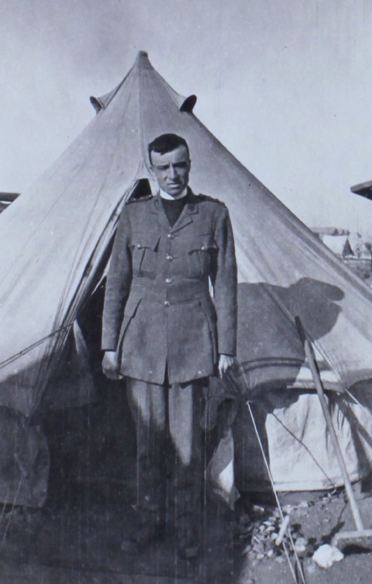 A chaplain outside a tent