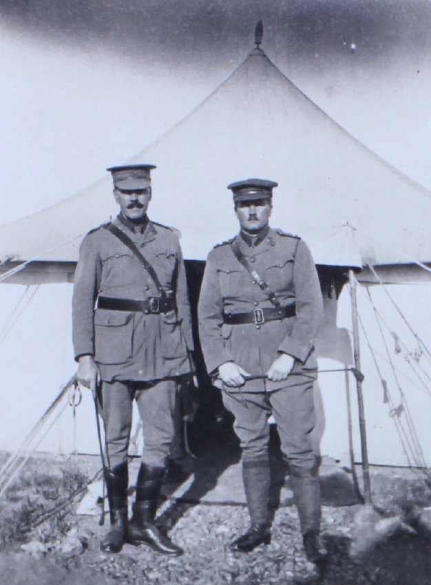 Two officers outside a tent