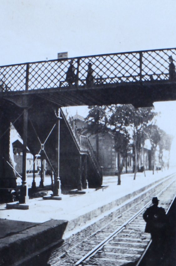 Railway platform with a footbridge over the rails
