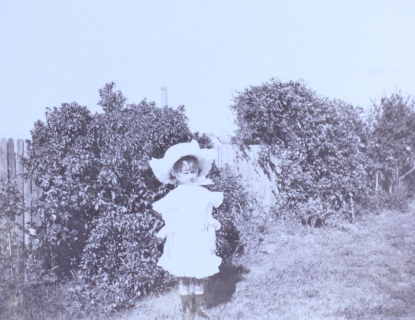 Young girl standing in the garden
