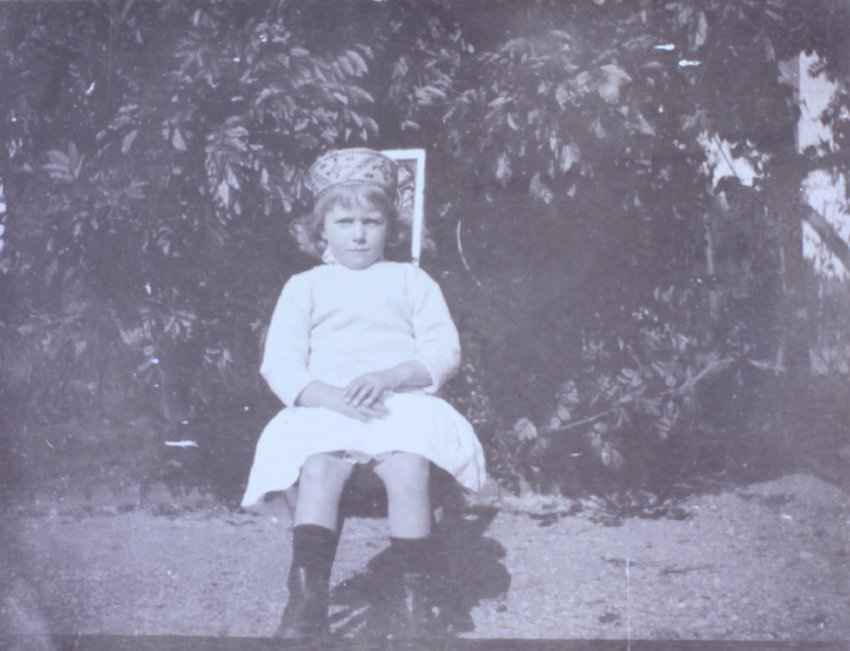 Young girl sitting on a chair in the garden