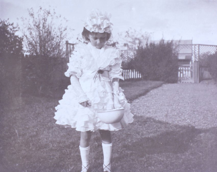 Girl dressed as Little Miss Muffet with bowl and spider