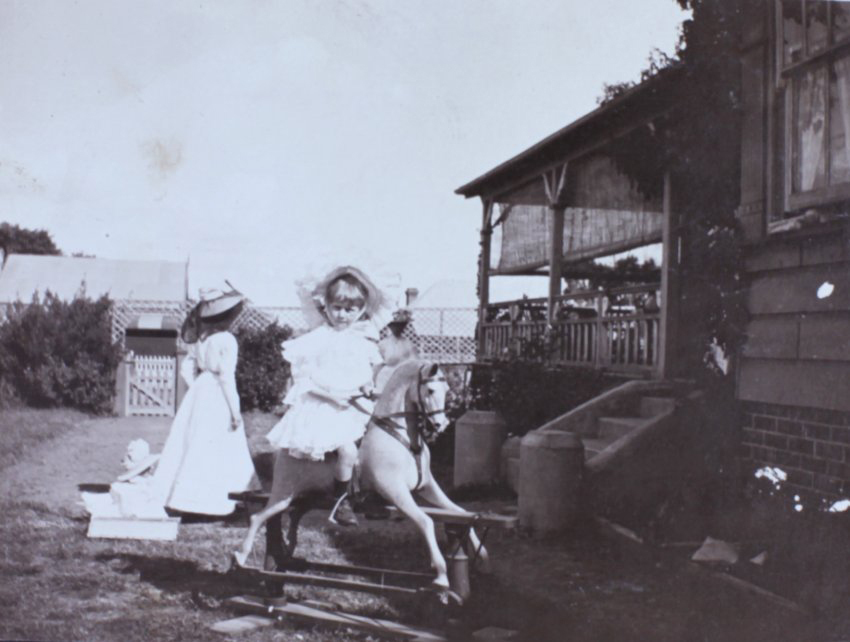 Young girl riding a rocking horse
