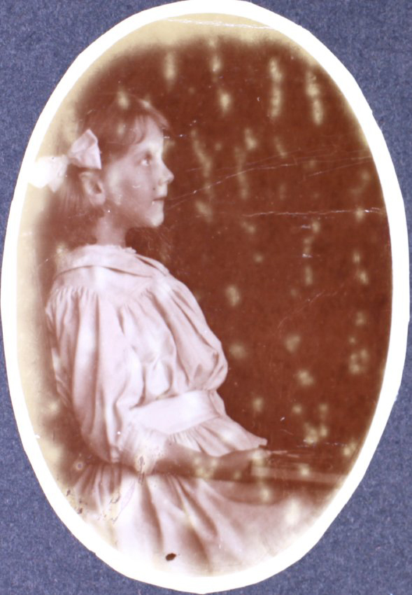 Young girl sitting - photo in profile