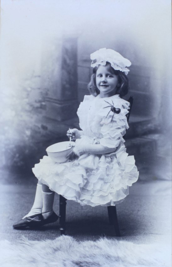 Young girl sitting with bowl and spider