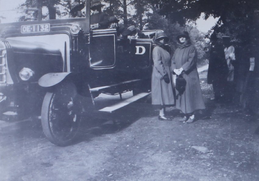 Two women standing near an open motor coach
