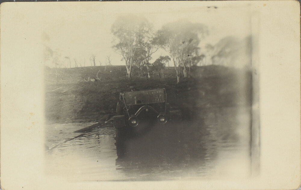 Car crossing flooded creek