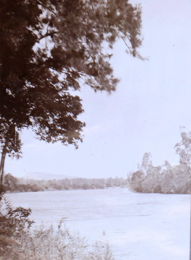 View down a river with buildings in the background
