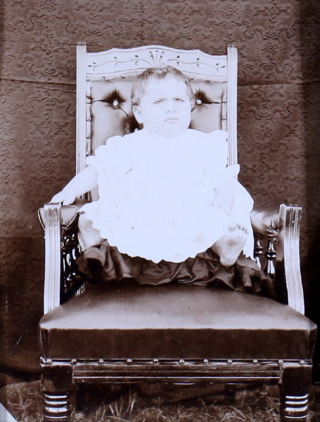 Small child sitting on a chair