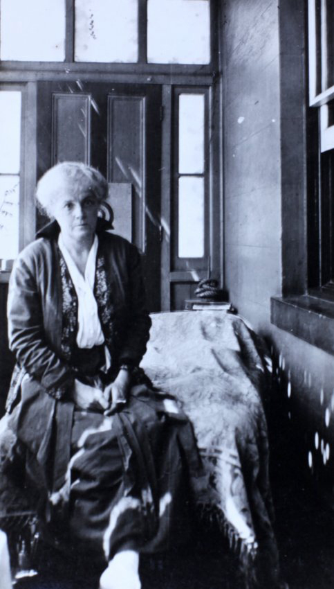 Woman sitting on the end of a day bed
