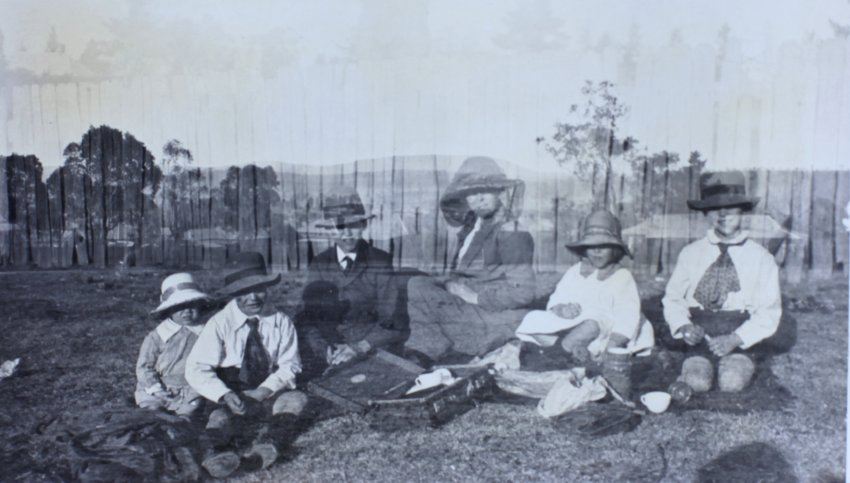 Woman and five children on a picnic