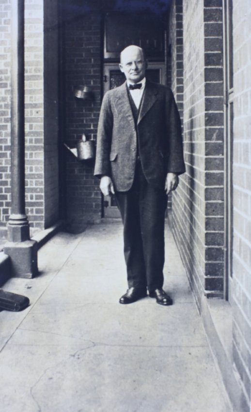 Man standing on a narrow verandah