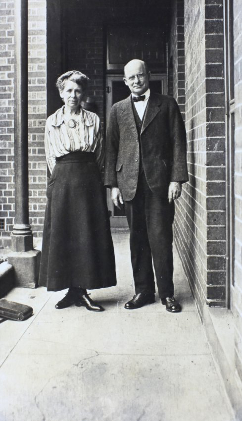 Man and a woman standing on a narrow verandah