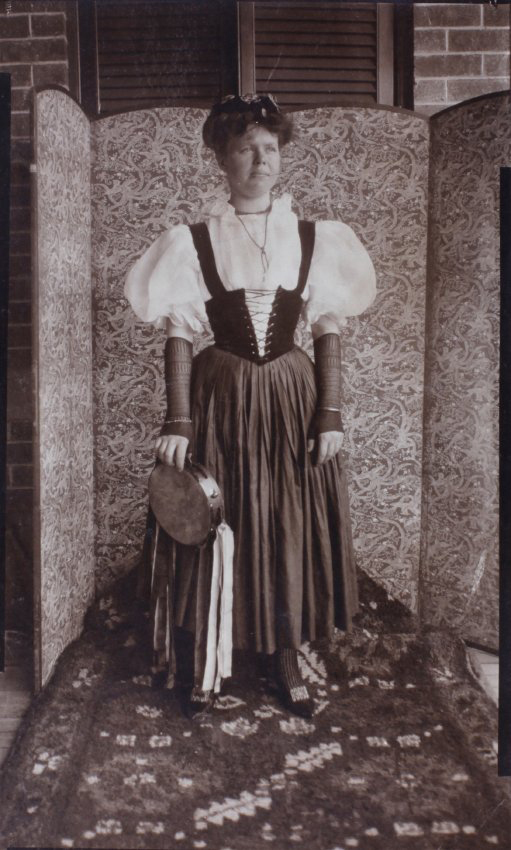 Woman in fancy dress carrying a tambourine