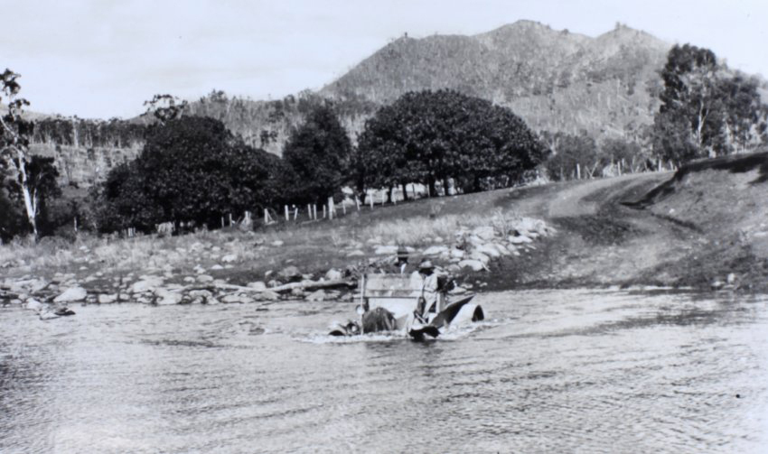 Driving a car through a flooded creek crossing