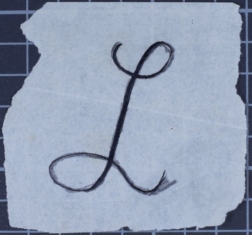 Loose sheet of paper with an L on it