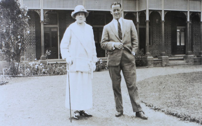 Unidentified man and woman standing in front of Sumarez homestead