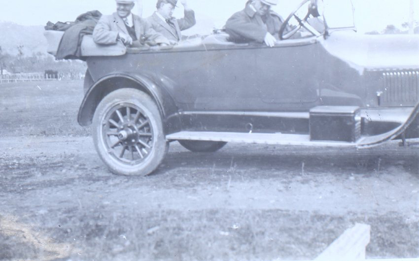 Three unidentified man sitting in a car