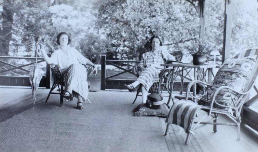 Two unidentified women sitting on a verandah