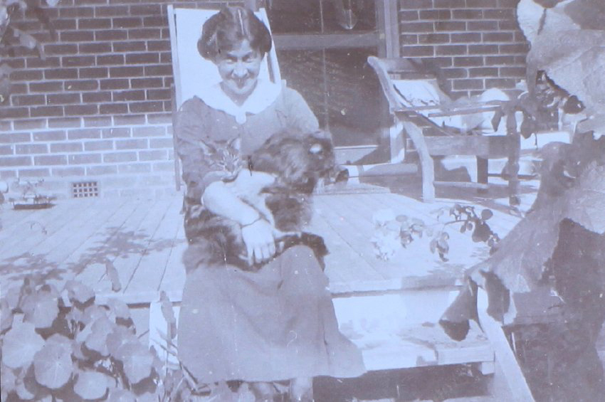 Unidentified woman with pet dog and cat