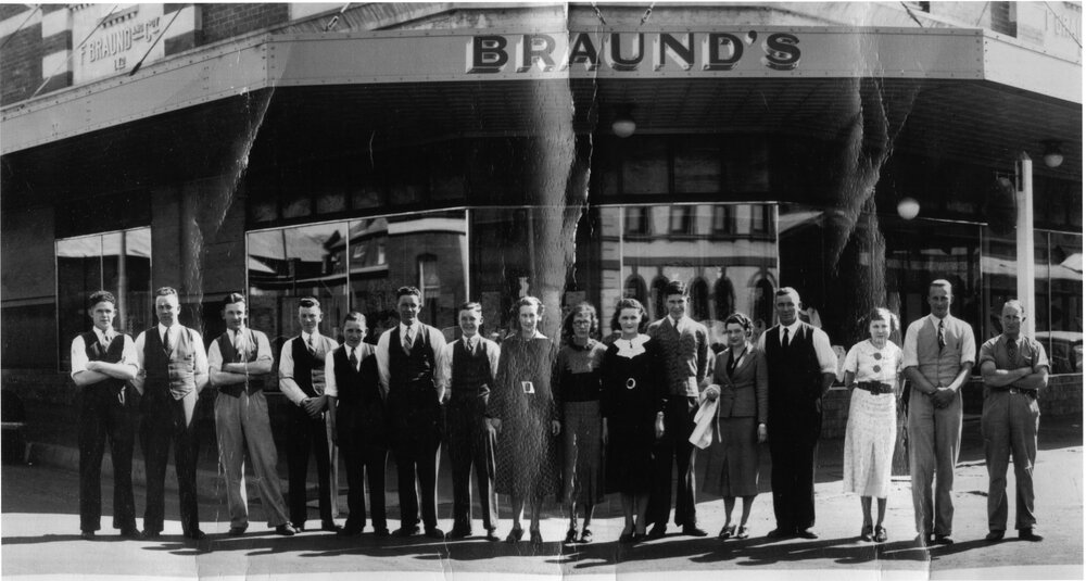Braund's Staff arranged around corner of shop, c. 1935