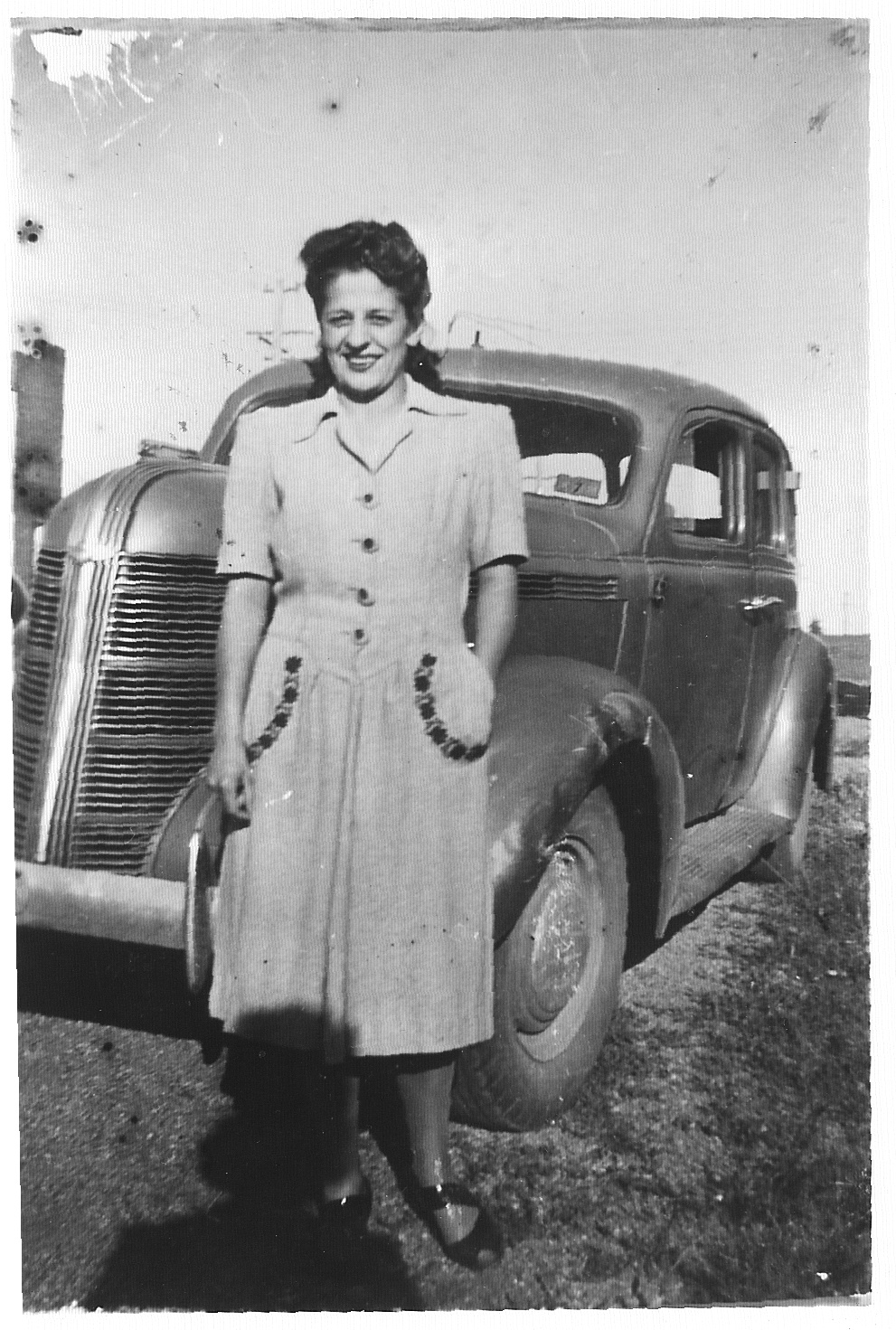 Dorothy Solomon in front of the Solomon family car, a Pontiac, early 1940s