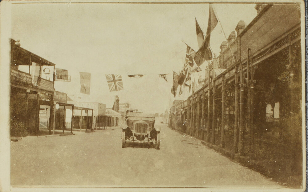 Beardy Street, from Imperial Hotel, with motor car and flags, [1918]