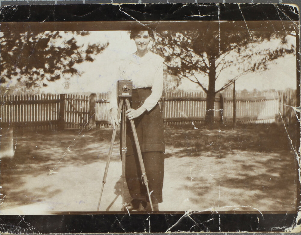 Girl with camera on tripod