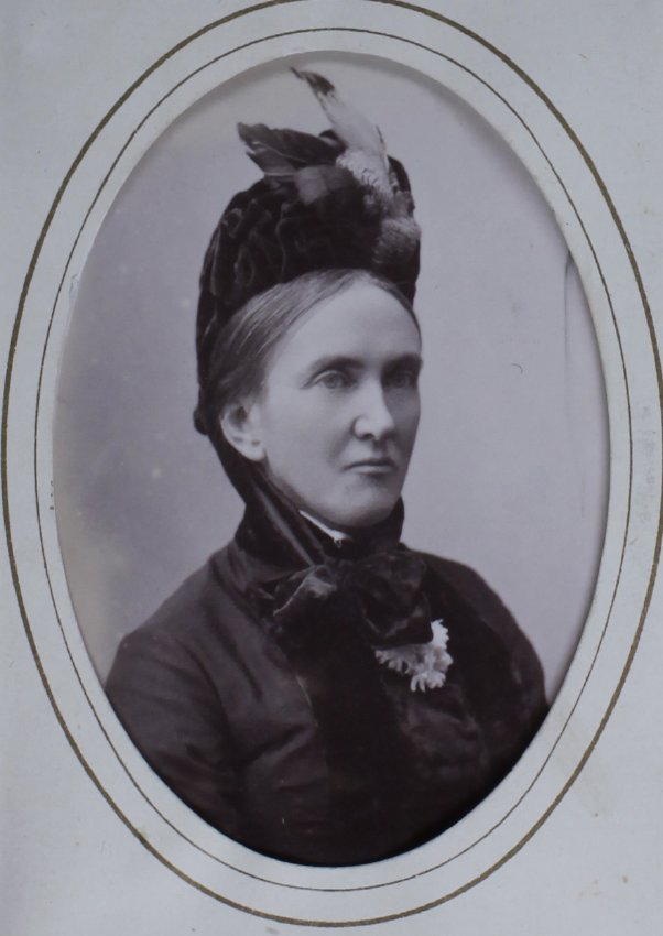 A carte-de-visite of a woman. The album page is annotated (in a modern hand) Mrs J Legh (?)