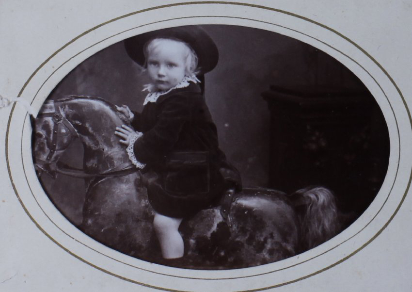 A carte-de-visite of a young child on a rocking horse