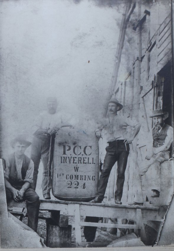 A group of men with a wool bale