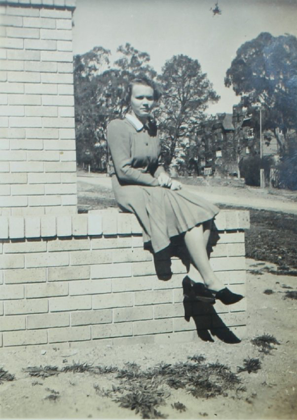 Dot, on the steps of the new Booth Block looking towards Booloominbah, 1940 