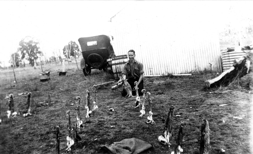 Laurie Hattersley with rabbit skins and joey